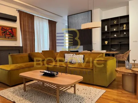 Spacious living room with a comfortable yellow sofa and a dining area in the background. - image 3