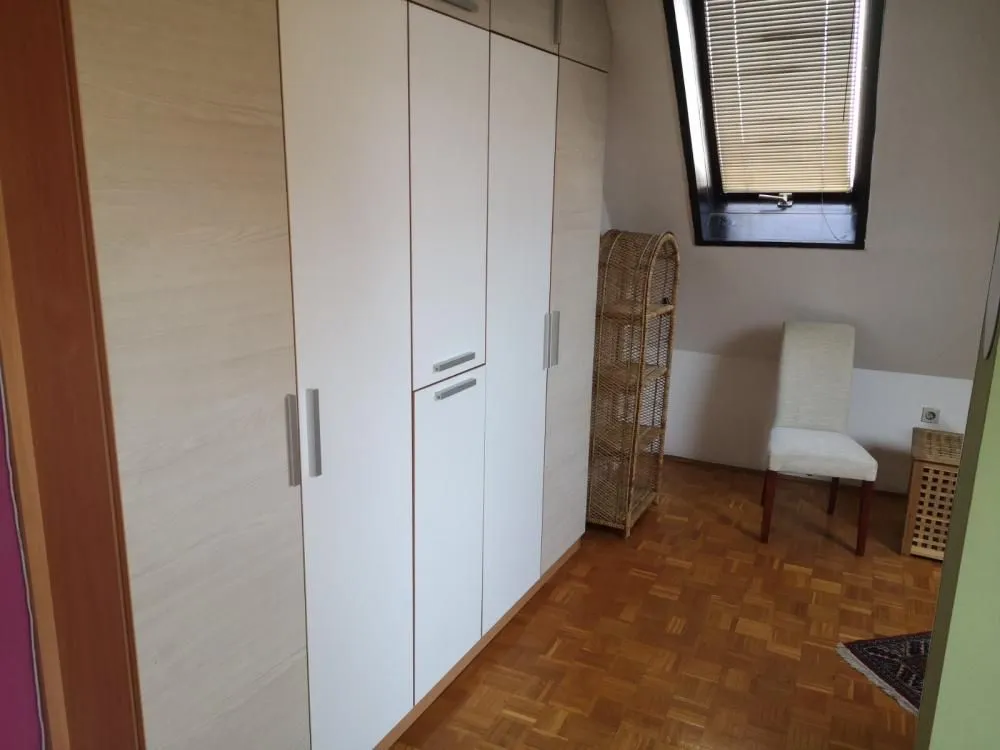 Bedroom with a large fitted wardrobe and a skylight.
