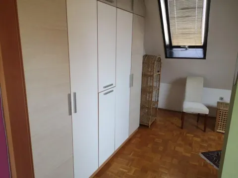 Bedroom with a large fitted wardrobe and a skylight. - image 6