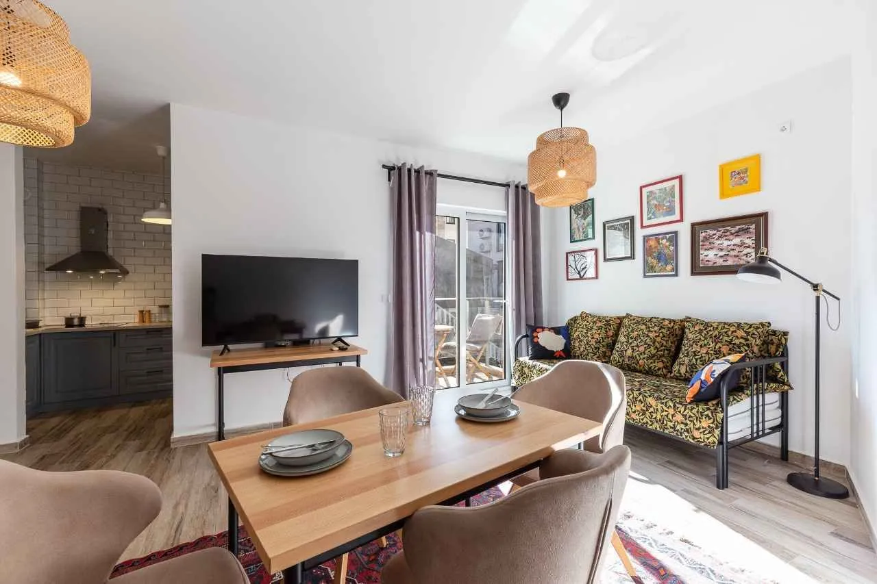Living room with a dining area and a view of the kitchen.