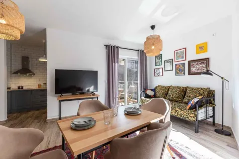 Living room with a dining area and a view of the kitchen. - image 6
