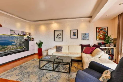 Bright and spacious living room with comfortable furniture and a TV. - image 2