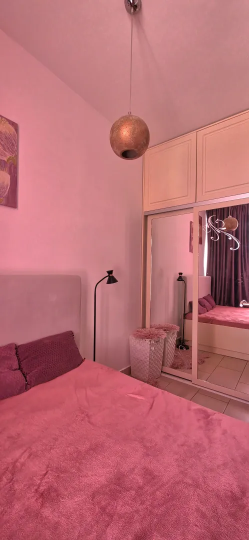 Modern bedroom with a double bed and a built-in mirrored wardrobe.