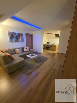 Living room with a sofa and a view of the dining area. - image 2