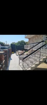 House yard with a paved path, outdoor stairs, and a seating set. - image 21