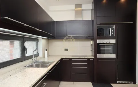 Modern kitchen with dark cabinetry and built-in appliances. - image 2