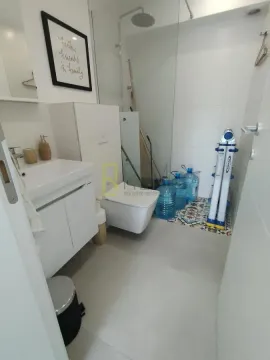 A messy bathroom with a washbasin, toilet, and shower cabin. - image 7