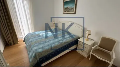 Bedroom with a double bed, bedside tables and an armchair. - image 9