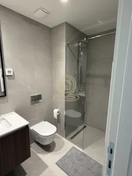 Modernly equipped bathroom with a walk-in shower and built-in fixtures. - image 11
