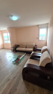 Living room with sofa set and glass coffee table. - image 3