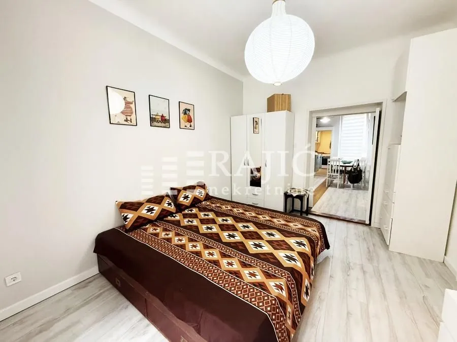 Furnished bedroom with a double bed and wardrobe.