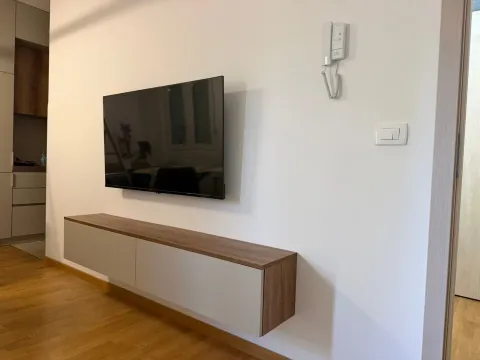 Living room with a TV and a wall-mounted console. - image 5