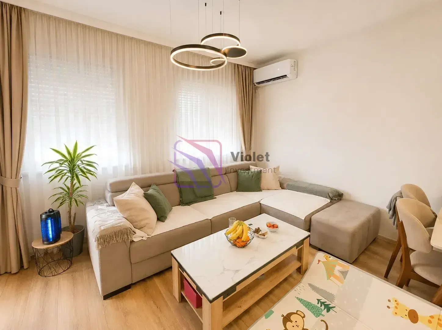 Udobna dnevna soba sa velikom ugaonom garniturom, stočićem i modernim osvjetljenjem.