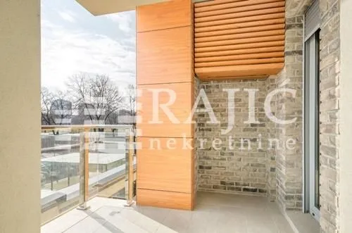 Spacious balcony with wooden paneling and a view of the surroundings.