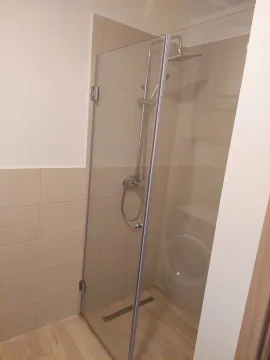 Modern bathroom with a shower cabin and glass partition. - image 12