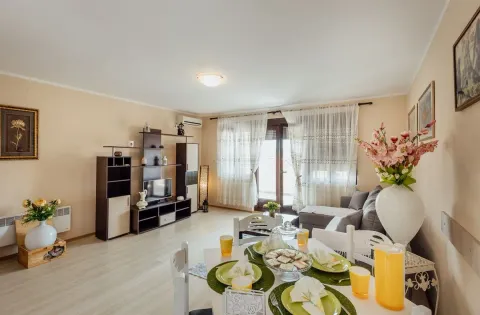 Living room with dining area, sofa set, and television. - image 9