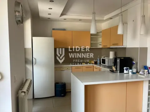 Kitchen with orange cabinets and a white refrigerator. - image 13