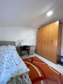 Furnished bedroom with a double bed, wardrobe, and desk. - image 8