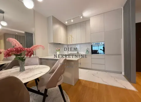 Modern kitchen with dining area and built-in appliances. - image 8