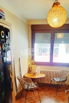 Small kitchen with a dining table and chairs by the window. - image 6