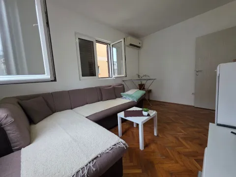 Living room with a sectional sofa, coffee table, and hardwood flooring. - image 6