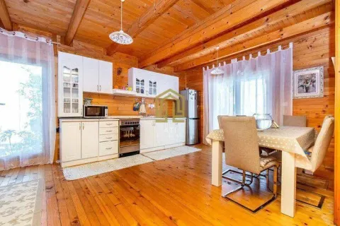 Wooden dining area with a kitchen in a cottage. - image 4