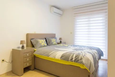 Bedroom with a double bed, bedside tables, and an air conditioning unit. - image 6