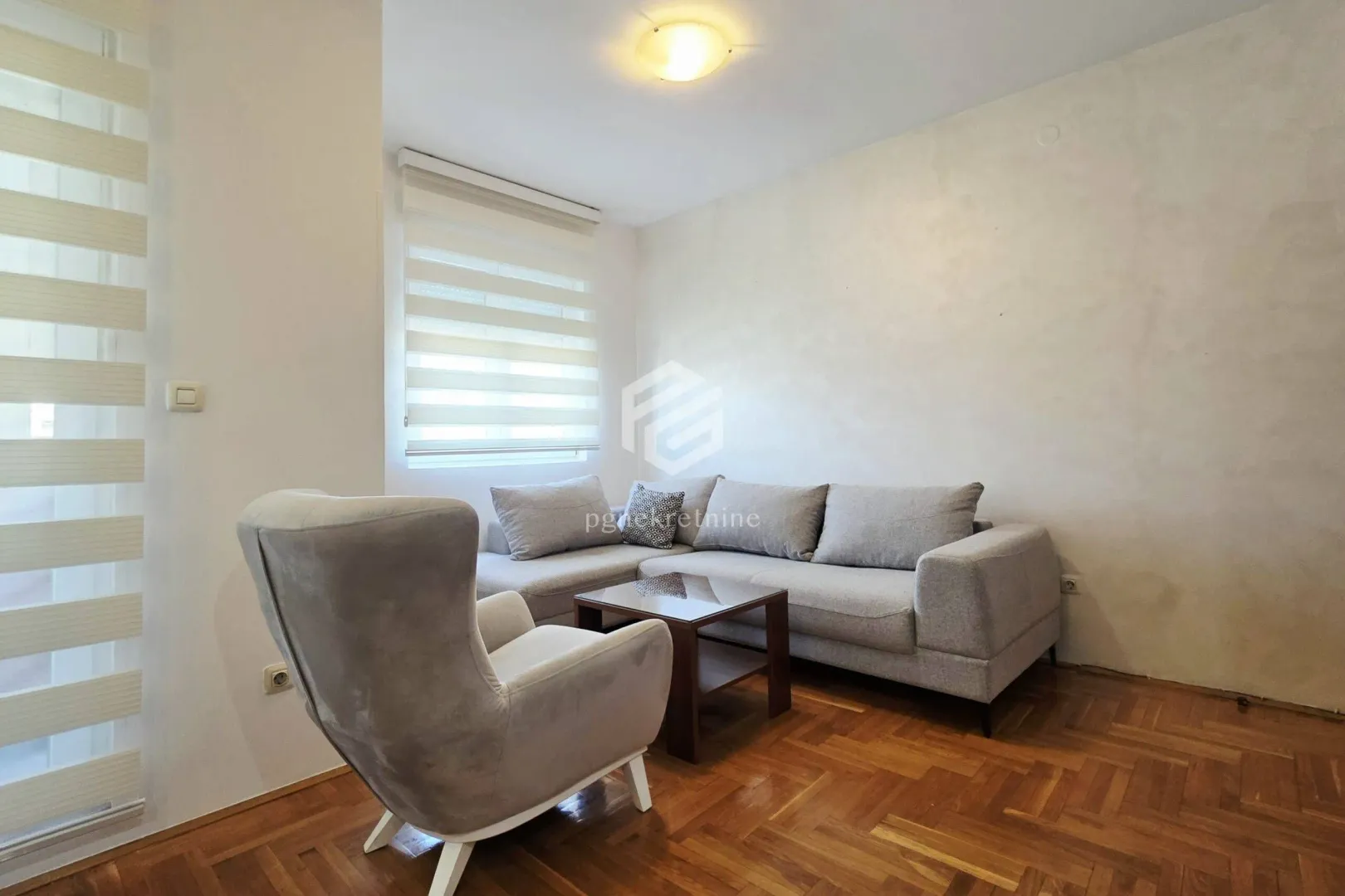 Living room with a corner sofa, armchair, and coffee table.