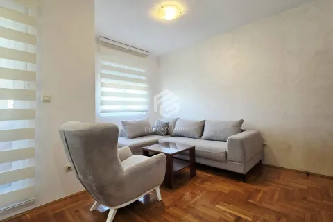 Living room with a corner sofa, armchair, and coffee table. - image 4