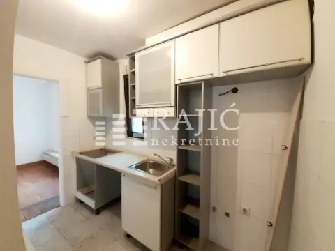 Small kitchen with cabinets and sink. - image 10