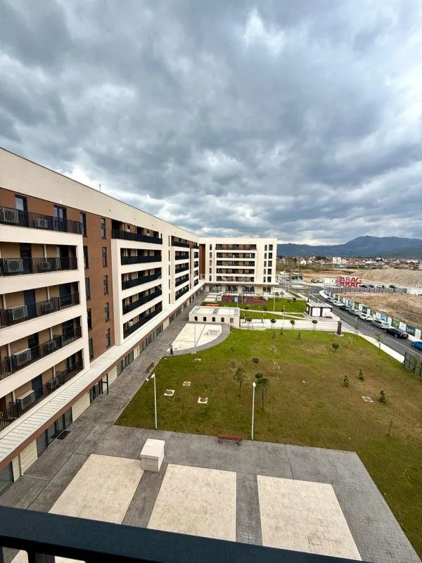 View from the terrace overlooking the courtyard and residential building facade.