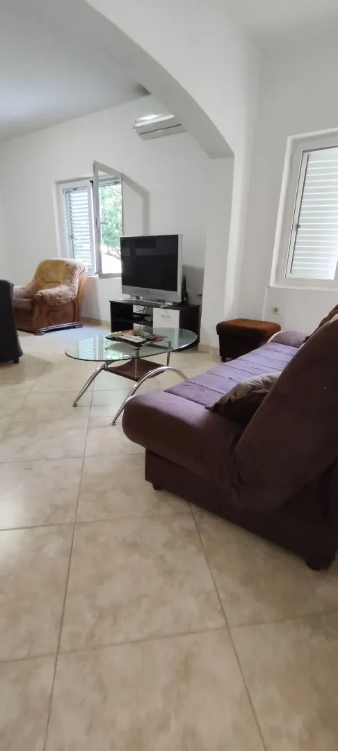 Spacious living room with a sofa and TV.