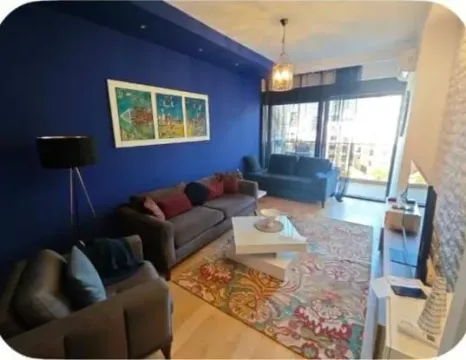 Spacious living room with sofa set and a blue accent wall. - image 2