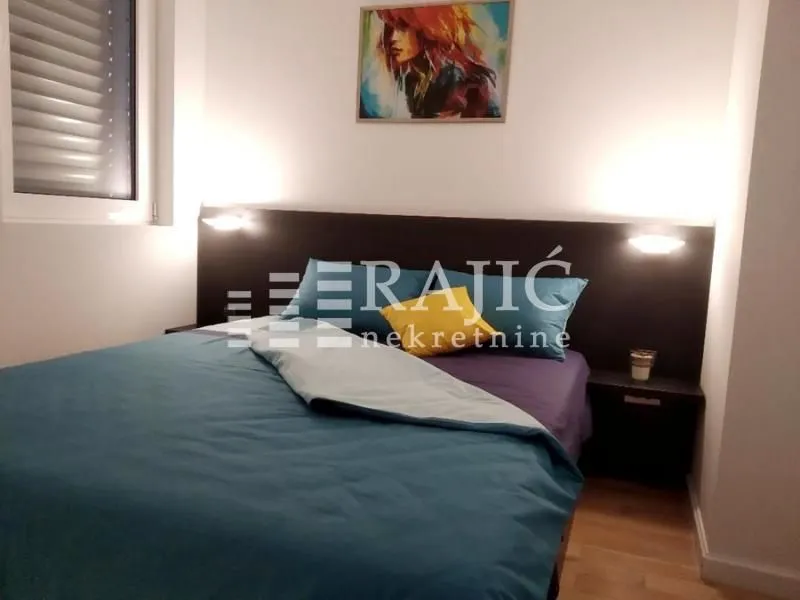 Furnished bedroom with a double bed.