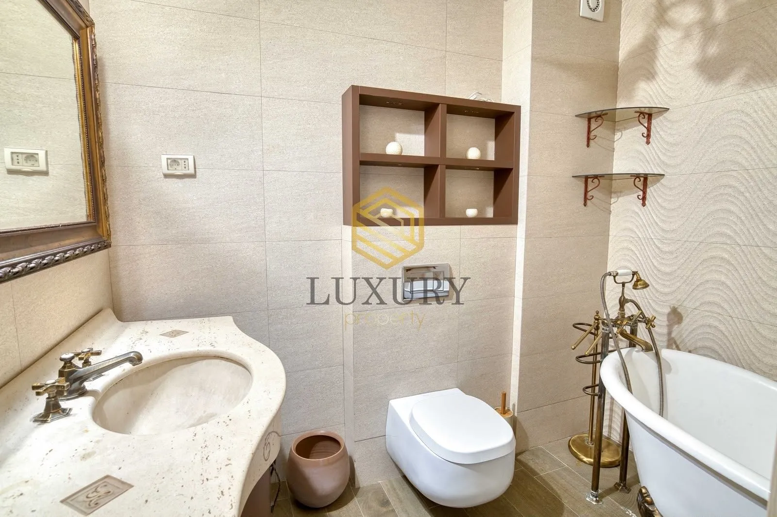 Well-organized bathroom with a bathtub, sink, and toilet.