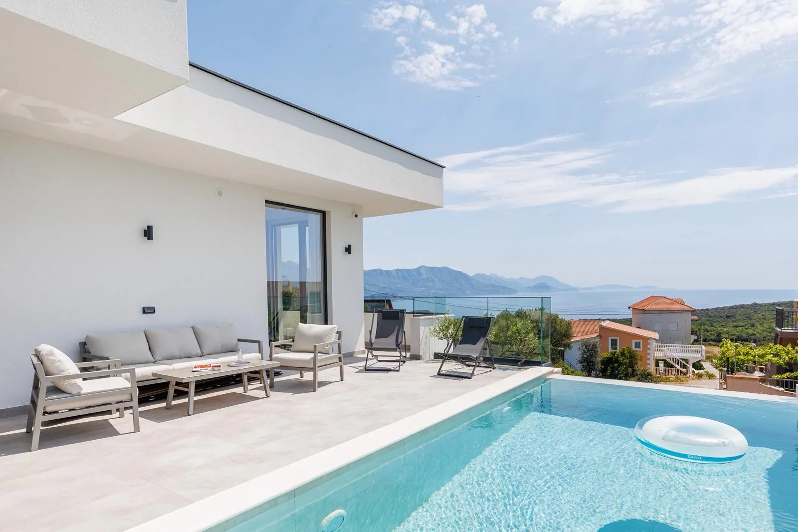 Terrace with a swimming pool and sea view.