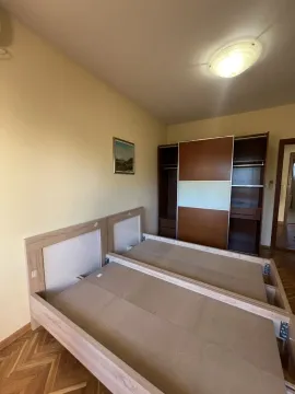 Bedroom featuring a wooden bed frame and a large wardrobe. - image 31
