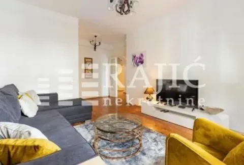 Spacious living room with a sofa and television. - image 4