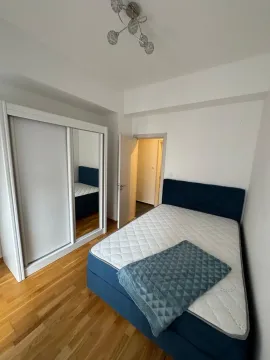 Bedroom with a double bed, mirrored wardrobe, and hardwood flooring. - image 10