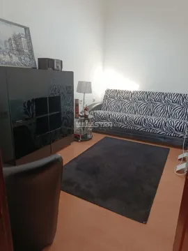 Living room with a sofa and a chest of drawers. - image 7