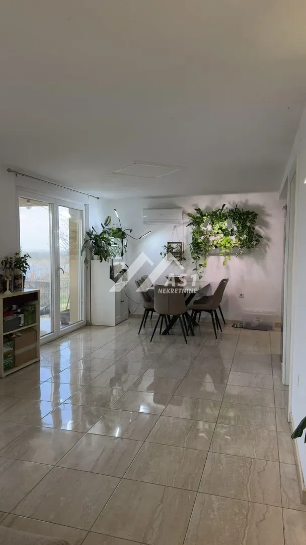 Spacious living room with dining area and terrace access.