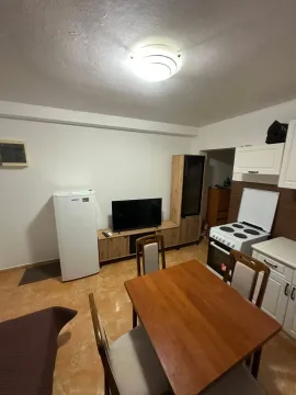 Dining area with kitchen and TV. - image 7