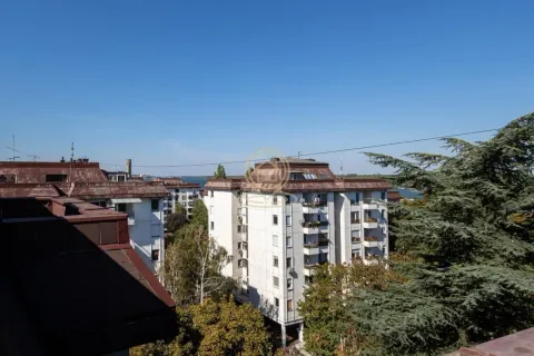 View from the terrace overlooking neighboring residential buildings and the surroundings. - image 14