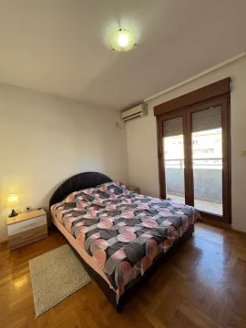 Bedroom with a double bed, nightstand, and access to the terrace. - image 6