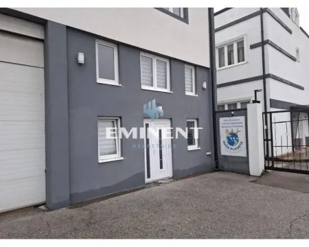 View of the building exterior with an entrance door and yard. - image 8