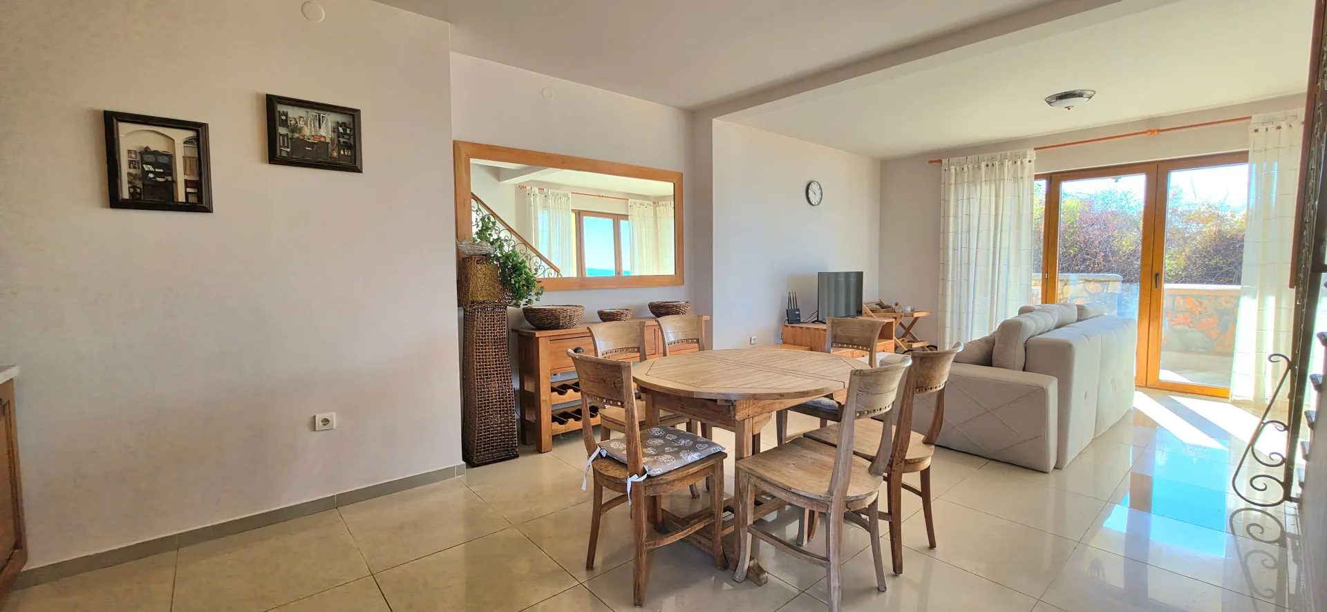 Spacious living room with dining area and sofa set.