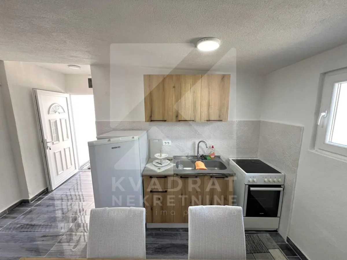 Small kitchen with a sink, stove, and refrigerator.