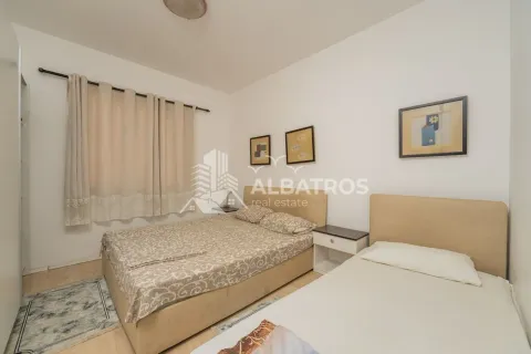 Bedroom with two beds, a window with curtains, and pictures on the wall. - image 4