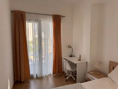 Furnished bedroom with a desk and access to the terrace. - image 6