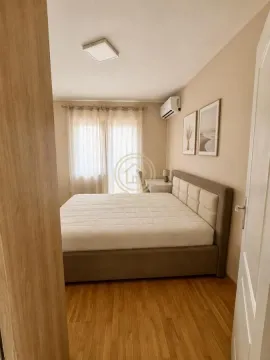 Furnished bedroom with a double bed, a desk, and a window. - image 11